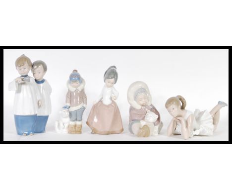 A collection of Lladro and Nao porcelain ceramic figurines to include Choirboys ringing a bell 01072 - boxed,&nbsp; Ballet Pe