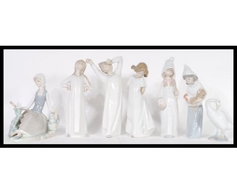 A collection of Lladro ceramic figurines to include model numbers 4870, 4678, 4872, 4677, 4660, 4553, a Lladro christmas bell