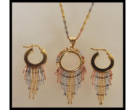 A demi parure set of earrings and a pendant necklace to include a pair of stamped 375 9ct gold hoop earrings with three tone 