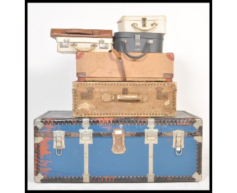 A collection of vintage retro 20th Century luggage to include a large blue and metal bound steamer trunk chest, various leath