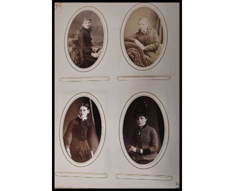 Two early 20th Century Edwardian photograph albums containing to include several family portrait photographs, portrait photog