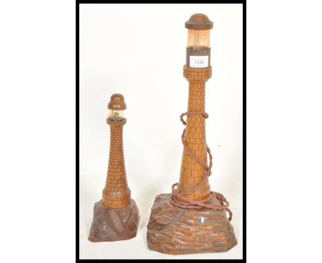 An early 20th century pair of graduating wooden Cornish table lamps in the form of a lighthouse complete with lamp atop. Toge