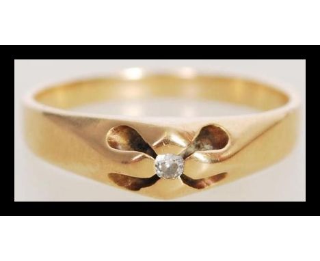 A stamped 18ct gold ring set with a brilliant cut white stone in a designer setting. Total weight 3.5g.