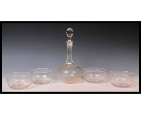 An early 20th Century Edwardian glass decanter and bowl set consisting of tall faceted glass decanter with four matching bowl