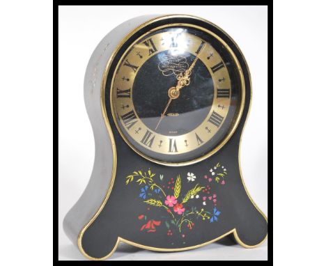 An early 20th Century Petite Neuchateloise balloon mantel clock for Jaeger, in black and gold detailing, floral swags, applie