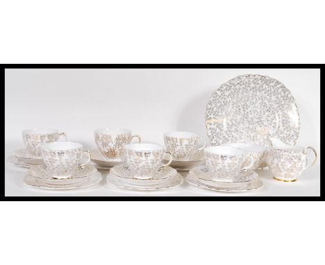 A vintage 20th Century Crown Regent part tea service having a white ground with gilt floral patterning, consisting of tea cup