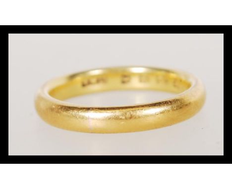 A hallmarked 22ct gold wedding band ring. Weight 5.4g. Size L. Hallmarked London 1934.&nbsp;