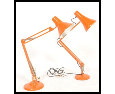 A vintage mid century Herbert Terry Industrial anglepoise desk lamp in an orange colourway together with another orange desk 