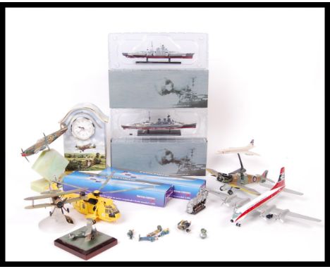 A collection of assorted scale diecast and model kits mostly aeronautical with some ships along with a clock having aeroplane