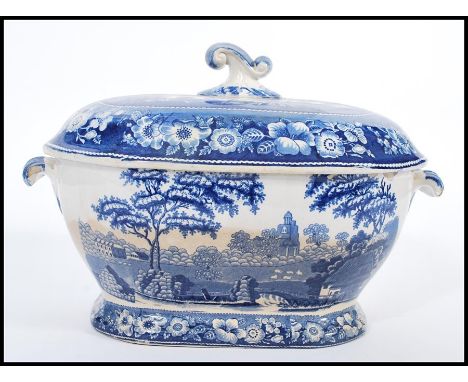 An early 19th century Georgian spode blue and white large tureen and lid having typical decoration with scrolled handles and 