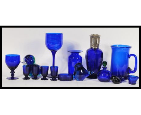 A collection of 20th Century blue glass wares to include a Bristol blue glass vase, a wine glass marked Esther, a Lampe Berge