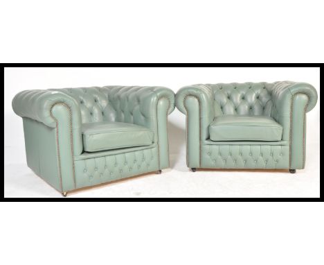 A pair of 20th Century&nbsp;mint green leather chesterfield armchairs with a barrel rolled arms and backrests being button ba