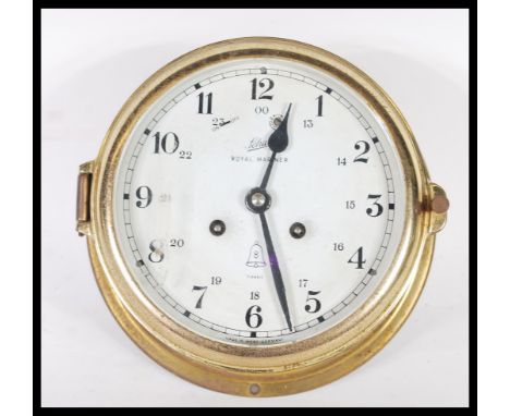 A vintage 20th century Royal Mariner 20th century brass cased bulkhead clock with white dial and 8 day movement. 18cm diamete