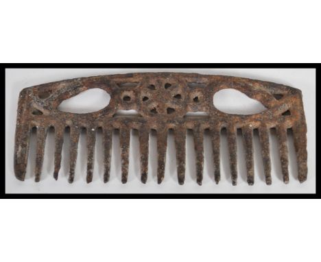 A rare antique 18th Century Georgian wrought iron horse grooming comb having central wheel decoration with pierced handles. 6