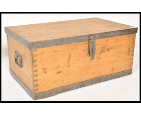 A 19th Century pine trunk coffer chest box having wrought iron drop handles and being wrought iron bound. The long rat tail h