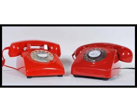 A pair of vintage retro 20th Century telephones having ring dial fronts with phones to top. Finished in a vibrant red. 12cm h