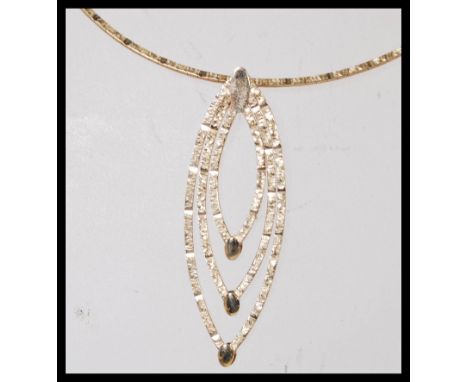 A stamped 375 9ct gold necklace having a snake chain with a graduating ellipse shaped pendant. Total weight 10.0g. Chain 45cm