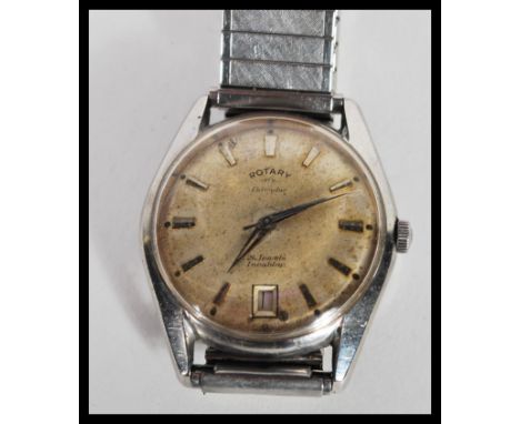 A vintage 1960s Rotary Calendar watch having a champagne dial with baton numerals and faceted hands. Set to an expanding watc