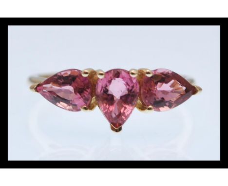 A hallmarked 9ct gold ring sprong set with three pear shaped pink stones. Hallmarked Birmingham. Weight 2.2g. Size P.5.