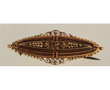 A hallmarked Edwardian 15ct gold bar brooch, the central raised panel raised in relief with foliate motifs, the brooch having