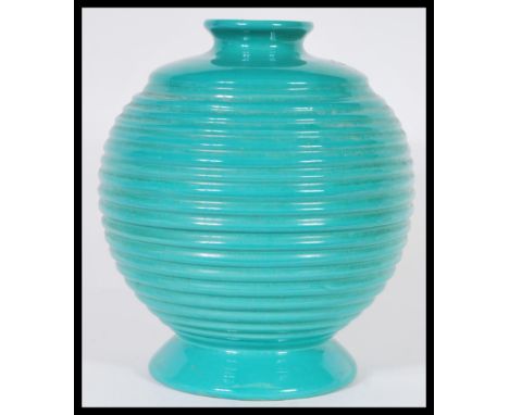 A vintage 20th Century Art Deco mint green ceramic vase of bulbous form having a reeded ripple effect to its bulbous body, ra