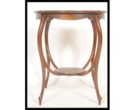 A Victorian mahogany lamp / side occasional table having pie crust top raised on slender supports with lower tier