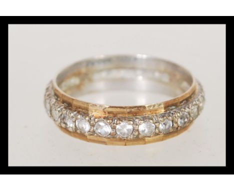A 9ct gold eternity ring being channel set with multiple white stones, complete in presentation box