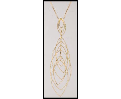 A 9ct gold ladies dress necklace with a curb chain and cascading ellipse drop detailing. Stamped 375. Weight 7.4g. Chain 45cm