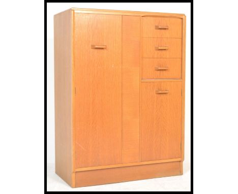 E Gomme for G Plan - light oak tallboy, with full length hanging cupboard to the left alongside three short drawers over a sh