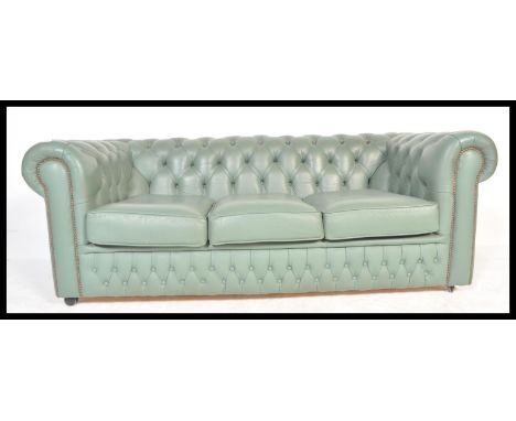 A 20th Century peppermint green leather chesterfield sofa with barrel rolled arms and backrest being button backed. The front