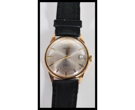 A hallmarked 9ct gold Avia 17 jewel incabloc watch having a silvered dial with gilt baton numerals faceted hands and date ape