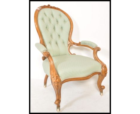 A 19th Century Victorian spoon back mahogany armchair or arm chair raised on ceramic castors with shaped supports. Good uphol