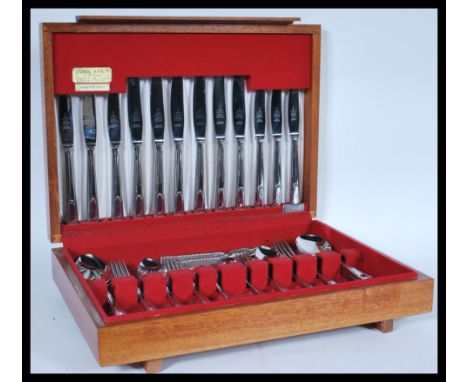 A vintage 20th Century James Ryals stainless steel canteen of cutlery in fitted wooden case. 9cm high 40cm wide.&nbsp;