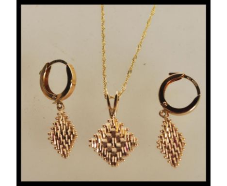 A demi parure necklace and earrings set to include a pair of hallmarked 14ct gold hoop earrings with diamond shaped gold drop