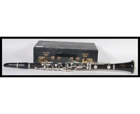 An Academy Besson &amp; Co rosewood clarinet complete in a fitted leather carry case, with a selection of reids. 67cm long.&n