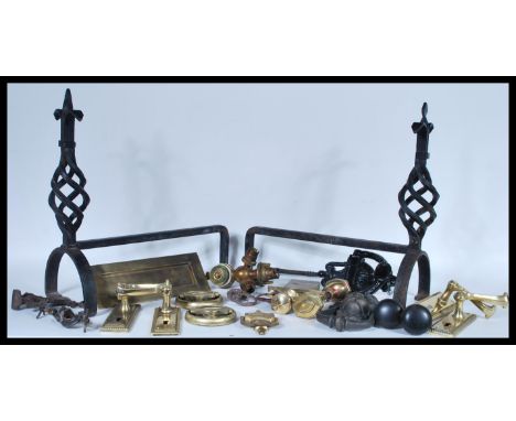 A collection of door furniture to include a Victorian cast iron door knocker, along with a lion mask door knocker and a brass