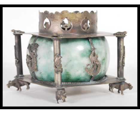 A Chinese late Qing Dynasty silver white metal censer burner raised on ox feet with four columns decorated with dragons. Cent