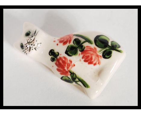 A 20th Century signed Wemyss ceramic brooch in the form of a cat having hand painted roses and features. Signed Weymss G. HP 