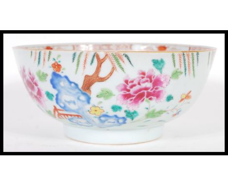 An 18th century small Cantonese Chinese ceramic bowl having hand painted floral spray with trees leaves and bridge. The bowl 