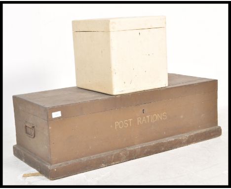 An early 20th century '' Post Rations'' brown wooden trunk having bound hinge top with swing handles to either. Together with