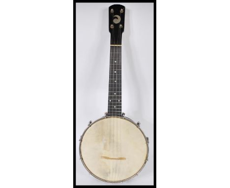 A vintage 20th Century John Grey and Sons four string banjo musical instrument complete in original fitted case. 56cm long.&n