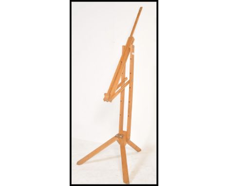 A 20th Century wooden folding artists easel of large form, raised on a tripod support.&nbsp;Measures: 177cm tall.