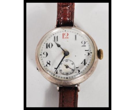 A vintage early 20th Century silver hallmarked gents WW1 era military trench watch having a white enamel face with Roman nume