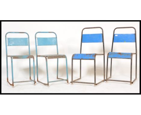 A set of four vintage retro 20th Century stacking chairs raised on tubular supports with panel seats and backrests.&nbsp;Meas