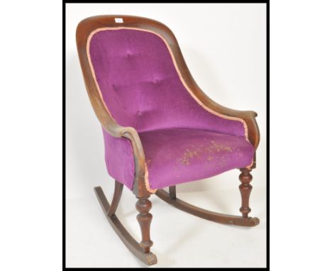 A 19th Century Victorian rocking chair raised on sleigh rockers and turned legs. The vibrant Royal purple upholstery having C