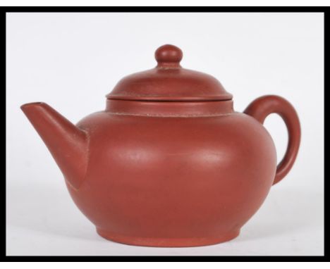 A Chinese Kang Yi Xing terracotta / stoneware teapot of simple form having impressed character marks to base. Measures 8.5cm 