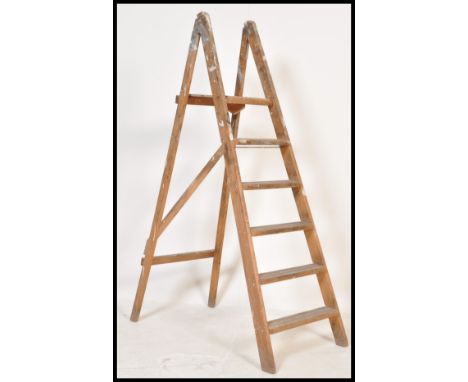 A vintage early 20th Century wooden Industrial folding step ladder. having six steps. Measures: 148cm tall.
