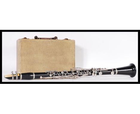 Musical Instruments. A 20th Century ebonised clarinet within a fitted handled carrying case. 69cm long.&nbsp;
