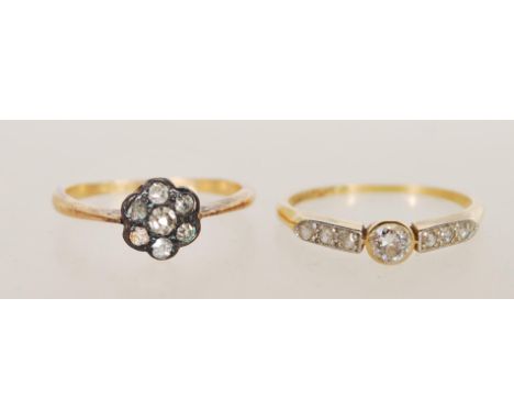 A hallmarked 18ct yellow gold diamond ring, set with a principal round brilliant cut diamond measuring approx, each shoulder 