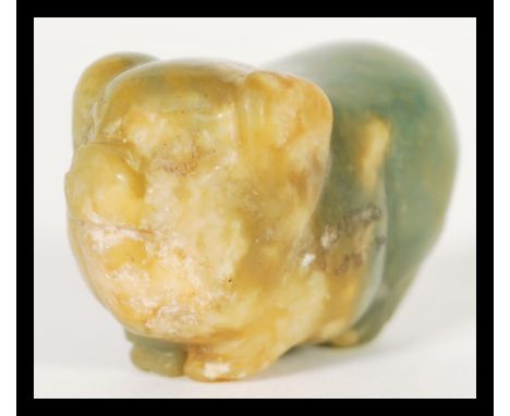 A 19th Century carved Chinese jade toggle or pendant in the form of a pig. Hole to body for string toggle. 3cm high 4cm wide.